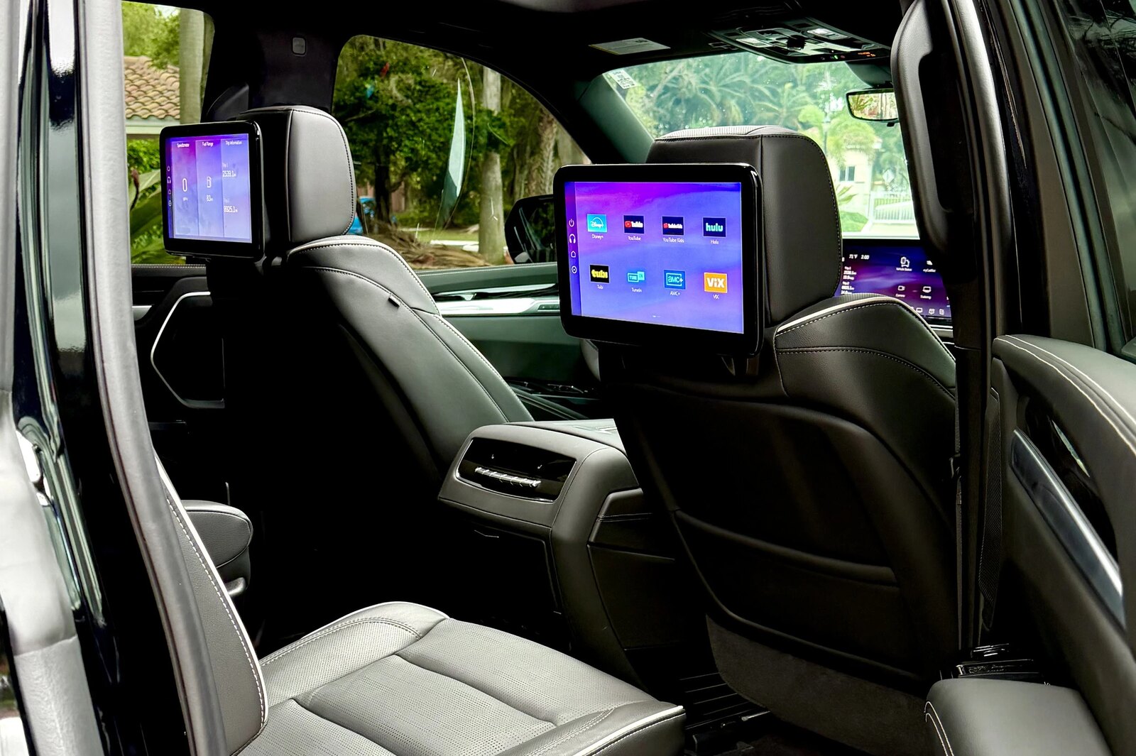 Cadillac Escalade cabin with leather seating and rear screens